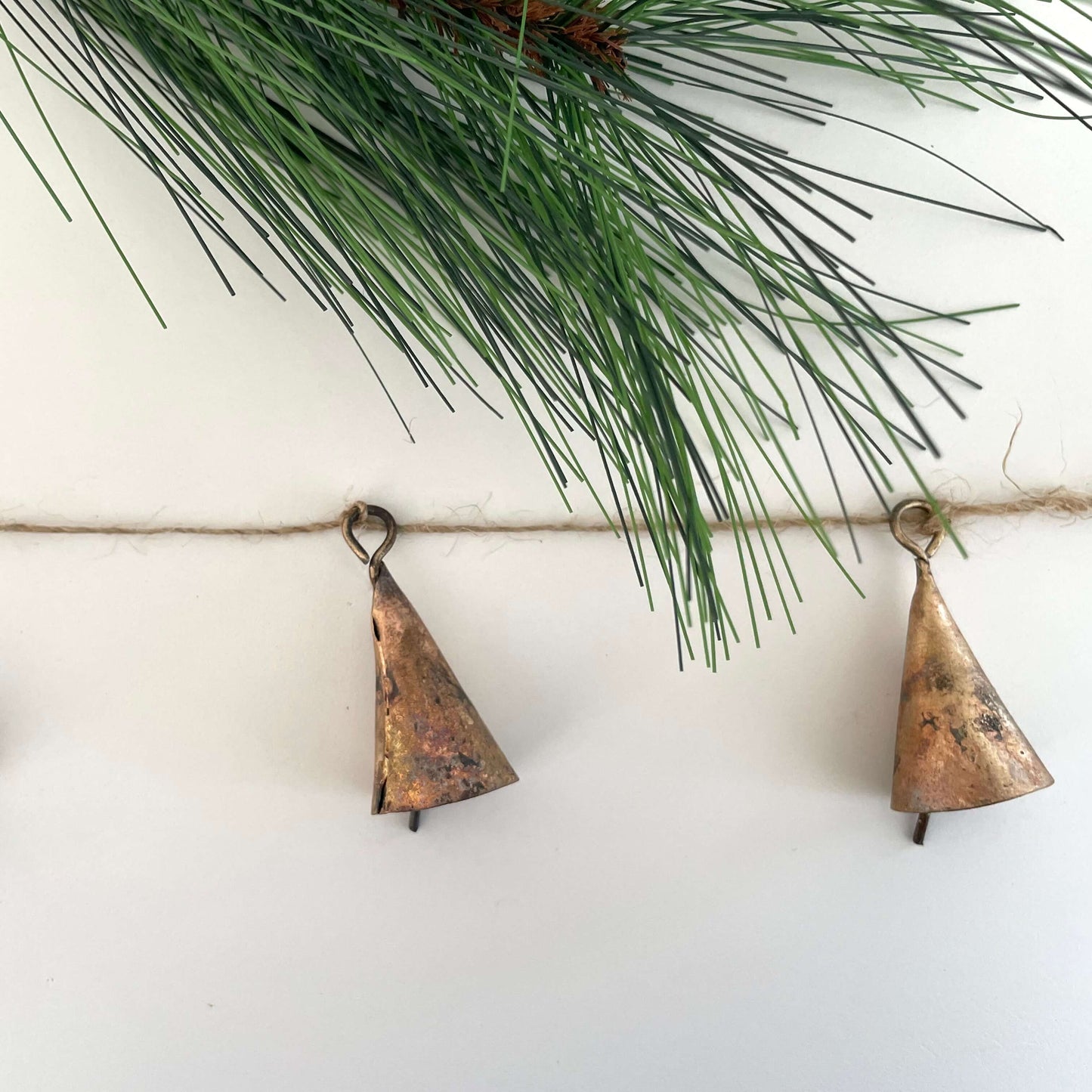 Rustic tin cone shaped brass bell jute holiday garland